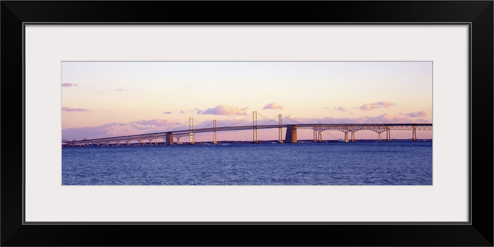 This large panoramic shot is taken of the Chesapeake Bay Bridge during a sunset.