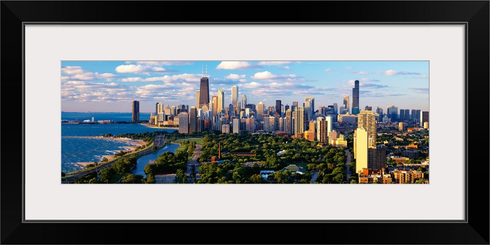 Panoramic photograph taken of the busy skyline of Chicago, Illinois on a sunny day.  The skyscrapers in the background are...