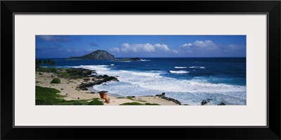 Coastal waves on Makapuu Beach, lifeguard climbing tower, Oahu, Hawaii