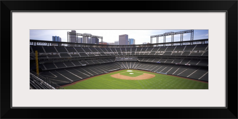 Panoramic, aerial photograph of Coors Baseball Field in Denver, Colorado.  A view of home plate surrounded by empty stands...