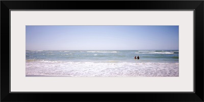 Couple standing in water on the beach, Gulf of Mexico, Florida,