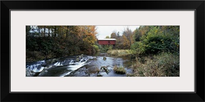 Covered bridge across a river, Northfield Falls, Vermont