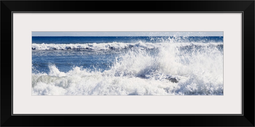 Panoramic photograph displays the Atlantic Ocean furiously breaking onto a sandy shoreline located on an island off the co...