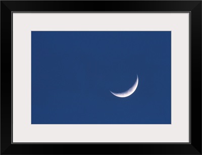 Crescent moon in deep blue sky