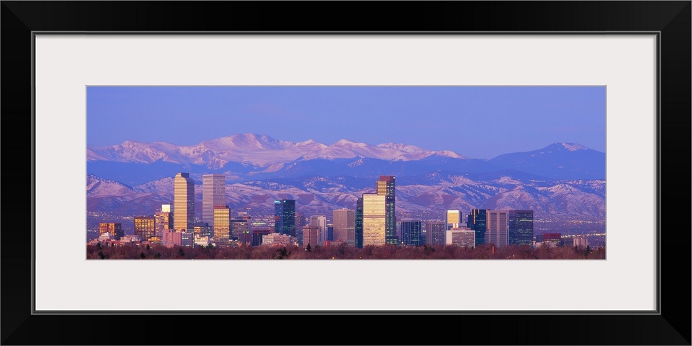 Panoramic view of the Rocky Mountains and downtown skyline of the Mile High City, Colorado in the early morning.