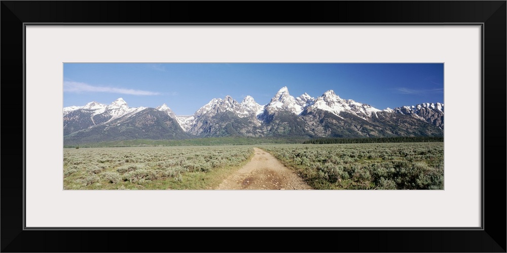 Dirt road passing through sage brush, Grand Teton National Park, Wyoming