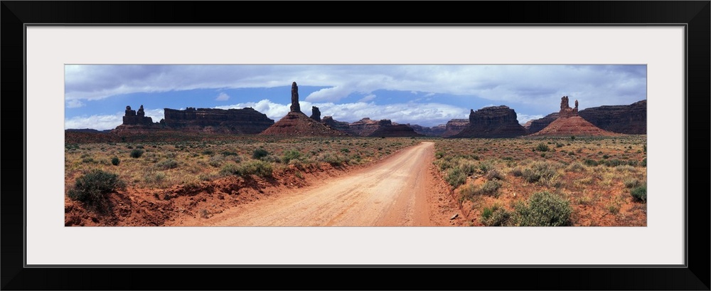 Dirt road through desert landscape with sandstone formations, Utah