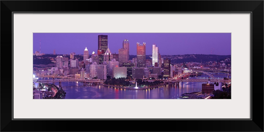 Big, wide angle photograph of Pittsburgh taken at night.