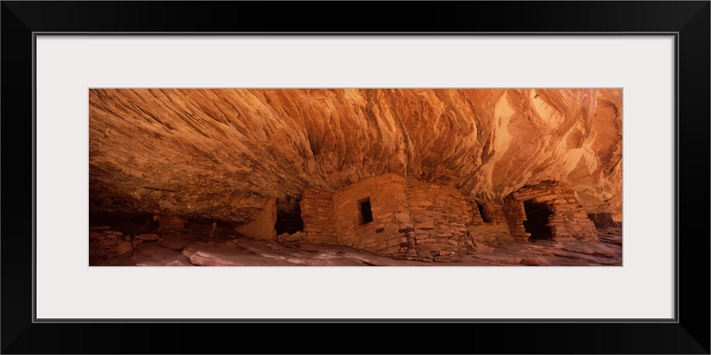 Panoramic wall art of ancient houses in the side of a cliff in Utah.