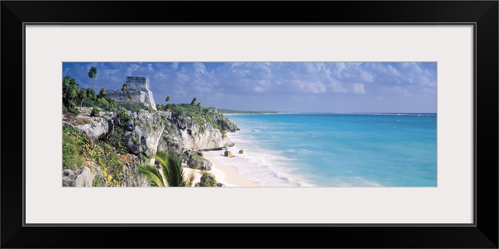 Cliffs that line the ocean coast in Mexico are photographed in panoramic view.