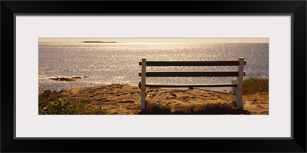 Panoramic photo on canvas of an empty bench overlooking a beach in the northeast US.