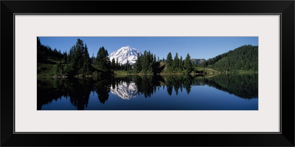 Panoramic photograph of Mount Rainier and surrounding green forest, reflecting in the still waters of Eunice Lake, in Moun...