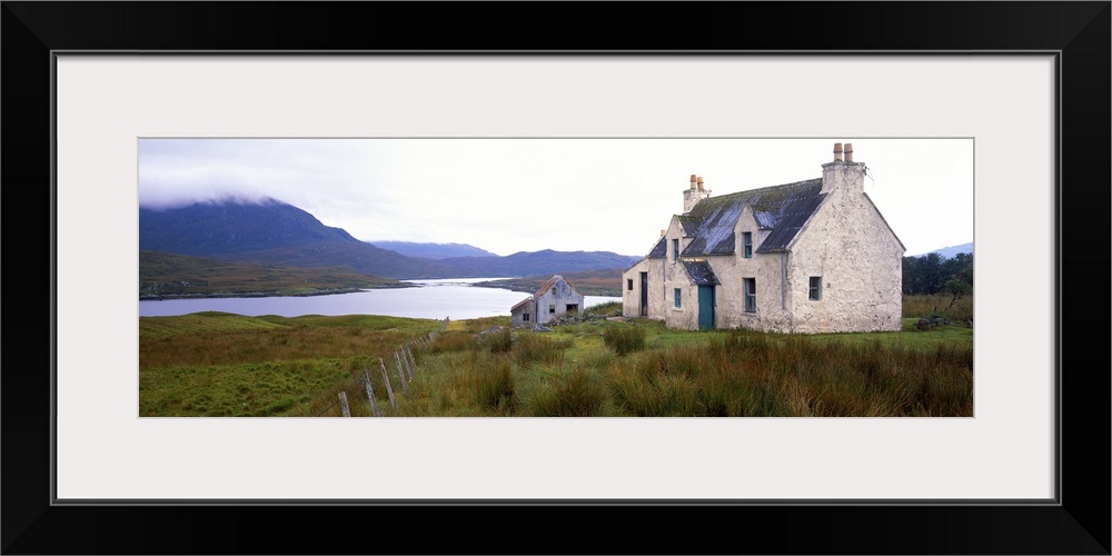 Farm house on bluff, mountains in mist, Isle of Lewis, Scotland