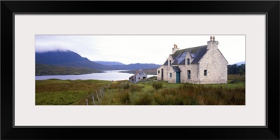 Farm house on bluff, mountains in mist, Isle of Lewis, Scotland