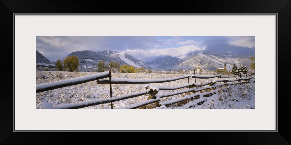 Fence on a snow covered landscape and a chapel in the background, Prince Of Peace Chapel, Aspen, Colorado