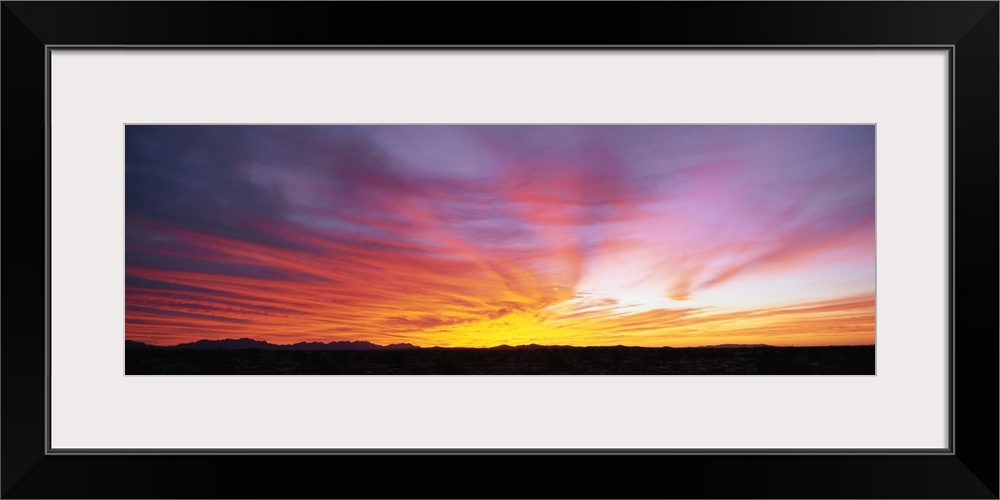 The strip of land at the bottom of this piece is silhouetted by the beautiful sunset that has dipped below the horizon.