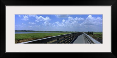 Florida, Sarasota, Myakka River State Park, Clouded sky over a wooden bridge