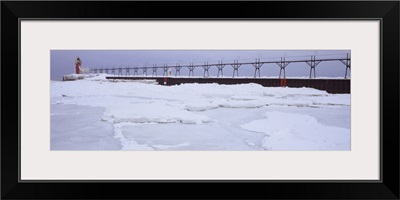 Frozen lake with a lighthouse in the background, Lake Michigan, St. Joseph, Michigan