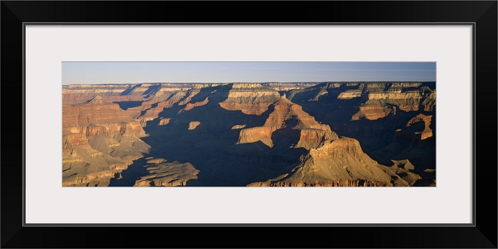 Panoramic photograph of the large rock formations of the Grand Canyon in the golden sunlight, in Arizona.