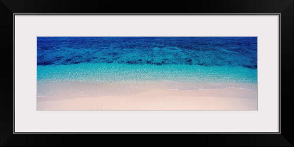 Panoramic aerial photograph of vibrant, clear blue waters along the sandy shoreline of Veidomoni Beach, in the Mamanuca Is...