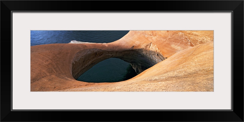 High angle view of a pothole arch at a lakeside, Lake Powell, Utah