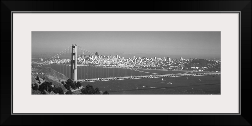 Panoramic photograph of iconic west coast city overpass with city skyline in the distance on a foggy morning.  There are b...