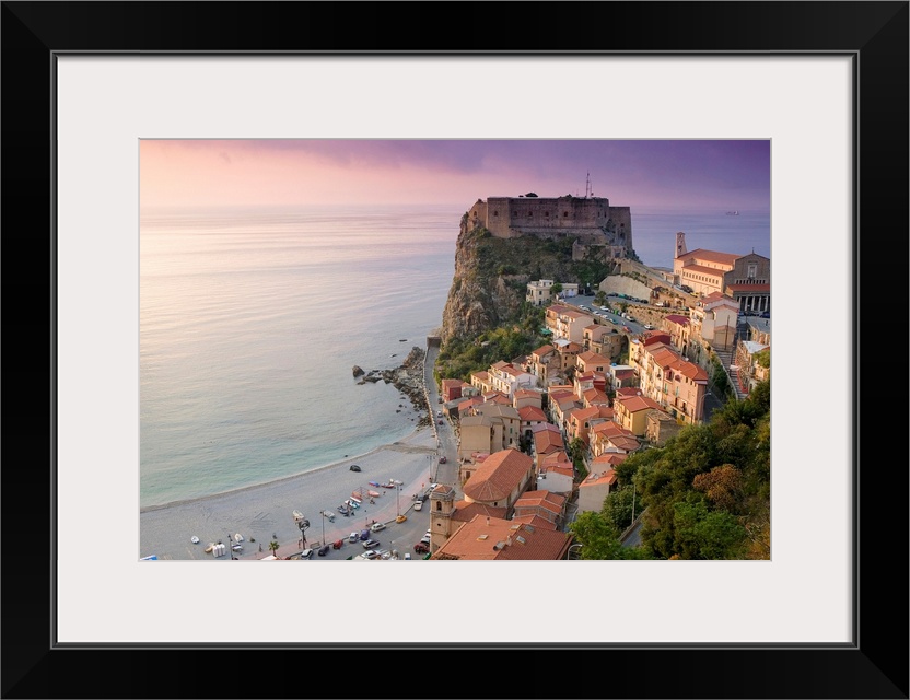 Large photograph taken of a fortress on the edge of a cliff with houses and buildings nearby as they all sit above the qui...
