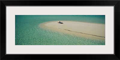 High angle view of a woman sunbathing on the beach, Maldives