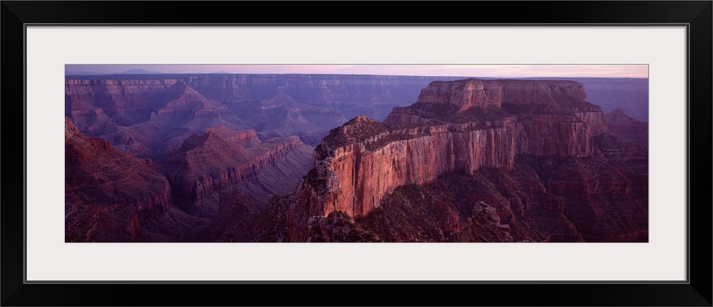 This aerial wide angle shot is taken of the vast Grand Canyon during dusk and only a sliver of the sky can be seen at the ...