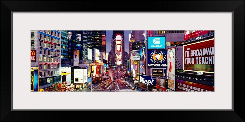 Panoramic photograph of neon signs and city streets downtown.