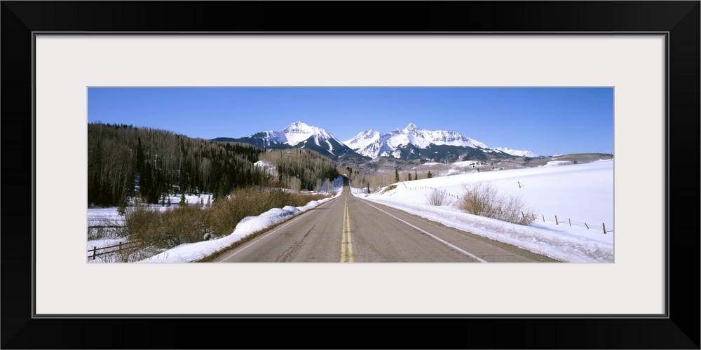 Highway in front of snowcapped mountains, Telluride, Colorado