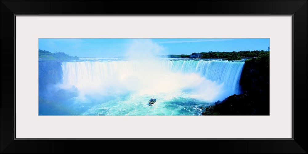 Long wall art of Niagara Falls rushing downward and a boat of tourists approaching it from the bottom.