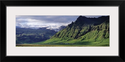 Iceland, South Coast, Sheer Basalt Cliffs, View of farm and cliff in the south coast