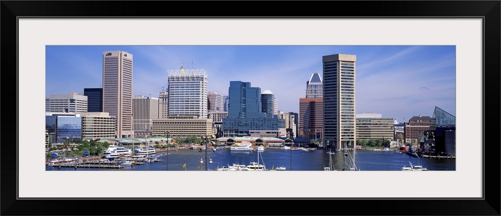 Panoramic image of the harbor area of downtown Baltimore, Maryland with sailboats and yachts parked in the marina.