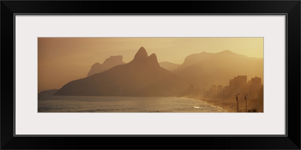 Giant landscape photograph of silhouetted mountains near the coast of Ipanema Beach in Rio de Janeiro, Brazil.