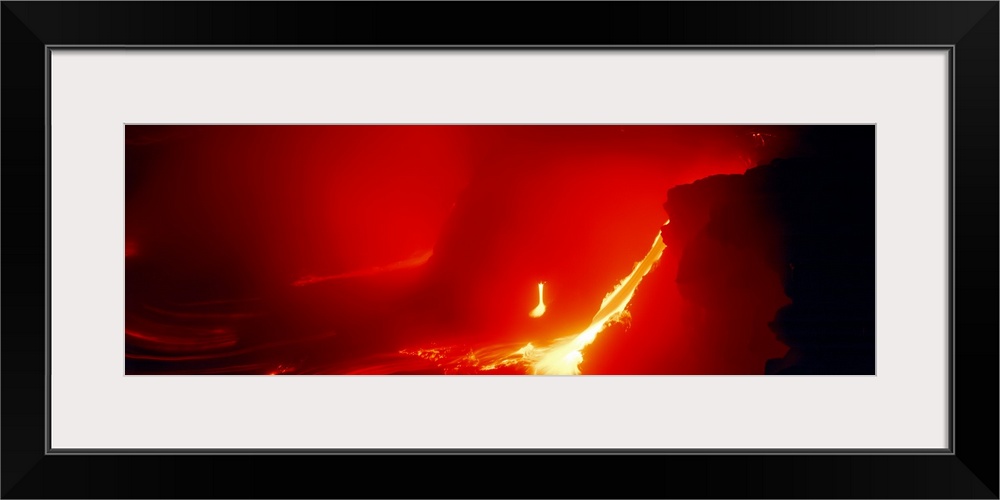 Glowing panoramic photograph of lava flowing from domed mountain.