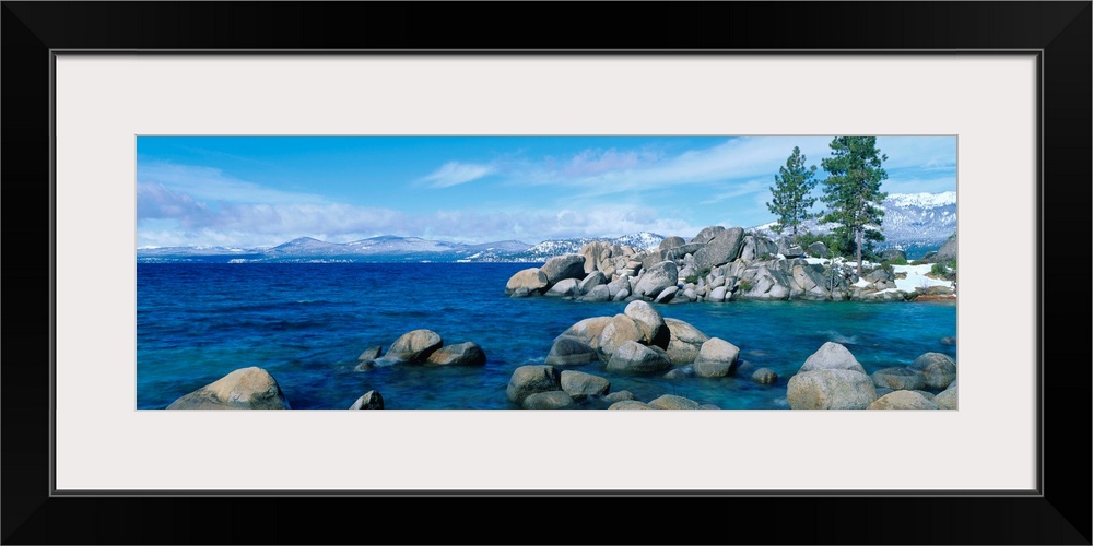 A panoramic photograph taken at eye level this home wall art shows the boulder covered shores of this world renowned lake.