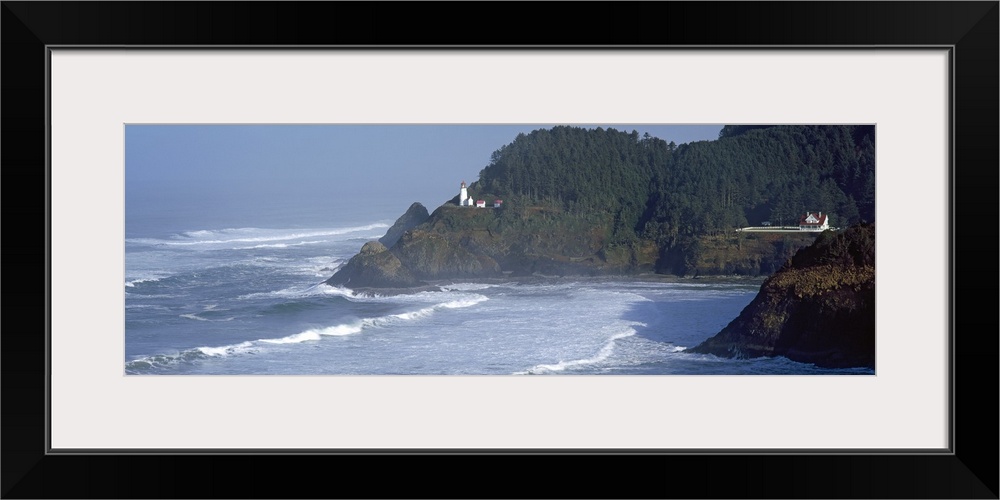 Large, landscape photograph of waves rushing against the shore in Heceta Head, Lane County, Oregon, the Heceta Head Lighth...