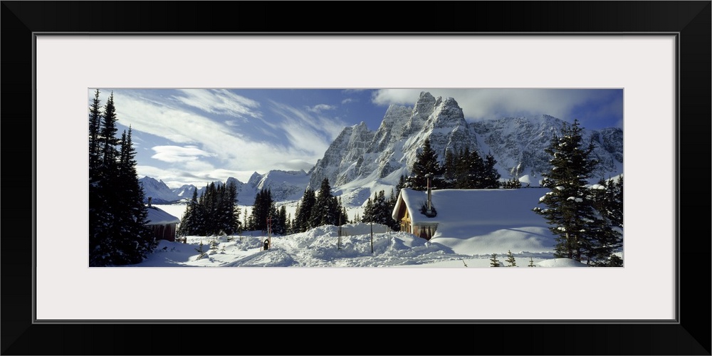 Lodge and mountains covered with snow, Tonquin Valley Backcountry Lodge, The Ramparts, Tonquin Valley, Jasper National Par...