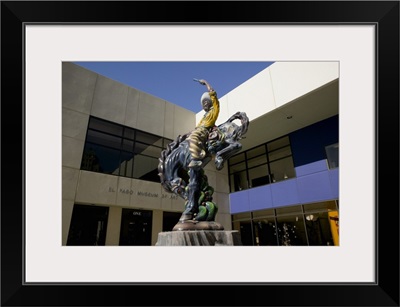 Low angle view of a statue of a cowboy on a bucking bronco in front of a museum, El Paso Museum Of Art, El Paso, Texas