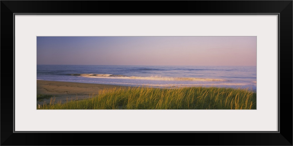 Wide angle photograph of Marram grass on the beach at Parker River National Wildlife Refuge in Massachusetts.  Waves can b...