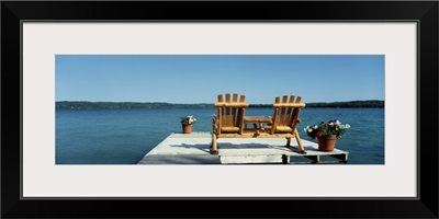 Minnesota, rear view of two Adirondack chairs on a dock