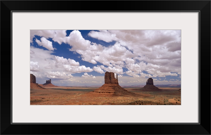 Horizontal photo on canvas of rock monuments in a desert in Arizona.