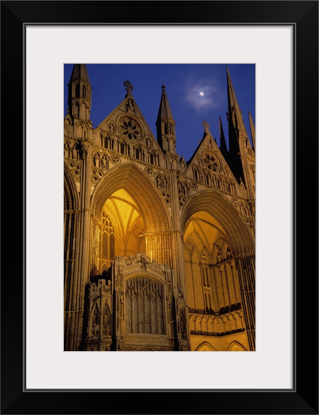 Moon over Peterborough Cathedral illuminated at night, Peterborough, England.