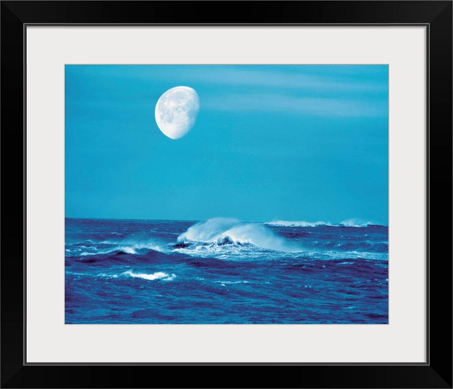 Moon over waves in sea