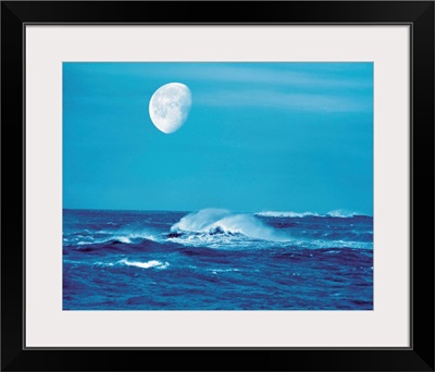 Moon over waves in sea