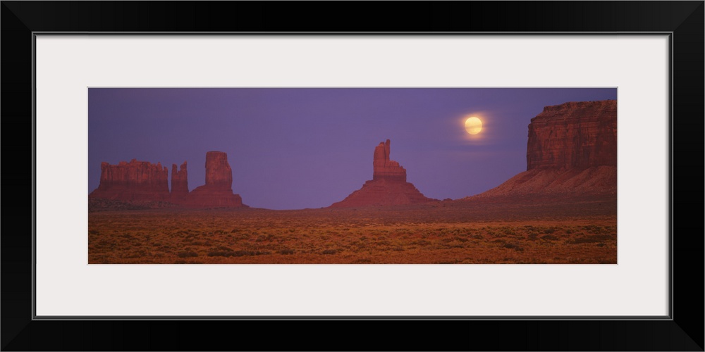 Moon shining over rock formations, Monument Valley Tribal Park, Arizona