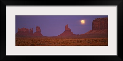 Moon shining over rock formations, Monument Valley Tribal Park, Arizona