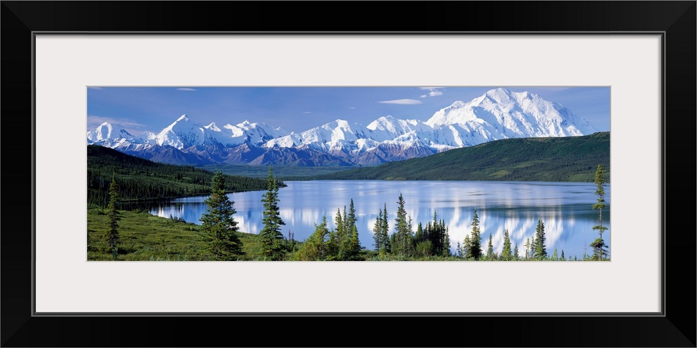 Panoramic photograph shows a landscape filled with trees as they surround and reflect into a lake within the Northwestern ...