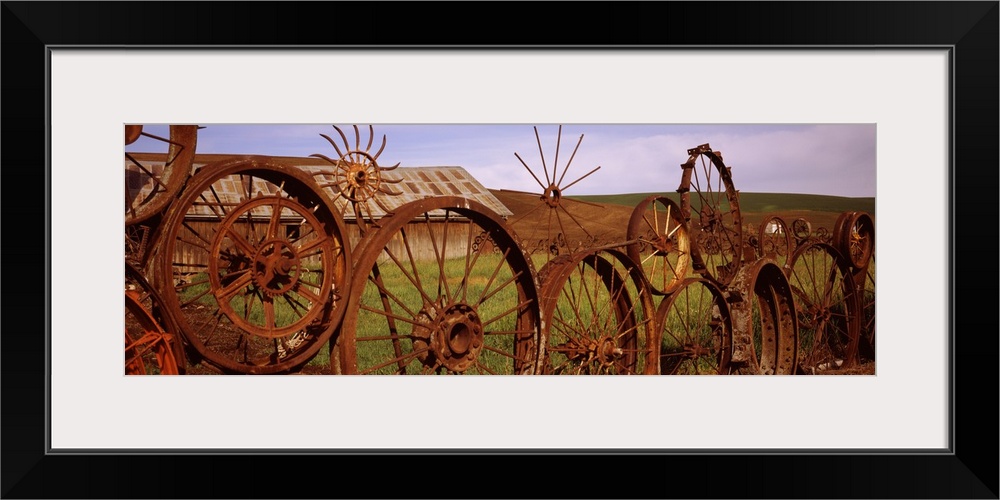 Old barn with a fence made of wheels, Palouse, Whitman County, Washington State,